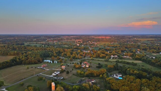 View of dramatic sunset over road in fields landscape on Akron Ohio US