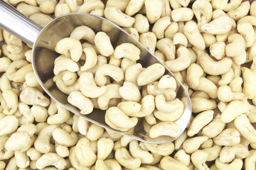 Cashew nuts with metallic scoop close up
