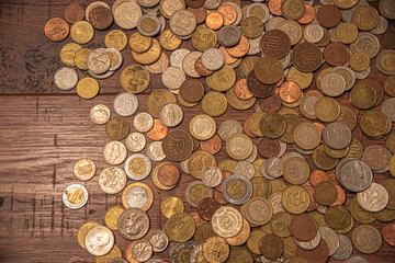 Coins from different countries. Pile of Golden, silver, copper, quarters, nickels, dimes, pennies, fifty cent, dollar coins, argentine pesos, real, euros, guarani currency. 