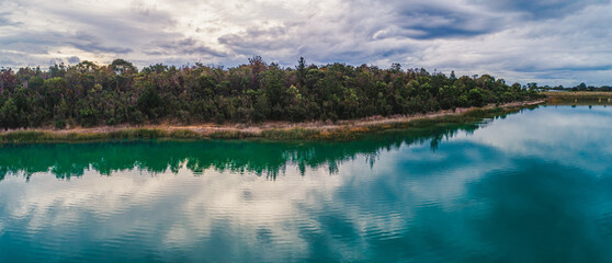 Panoramic view of native Australian vegetation reflecting in the lake water