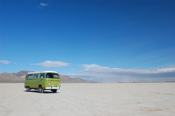 Camper van on a California dry lakebed - obrazy, fototapety, plakaty