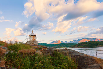 Fototapeta na wymiar Old lighthouse on the shore of the Saltstraumen straitat sunset.Norway