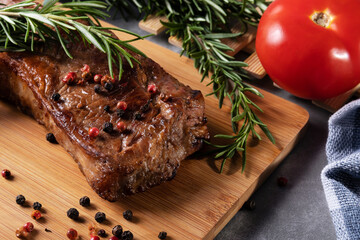 Grilled meat on cutting board with spices