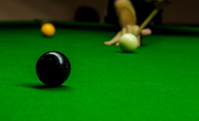 Man playing snooker balls on green snooker table