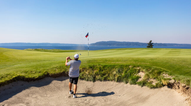 Male golfer hitting a bunker shot