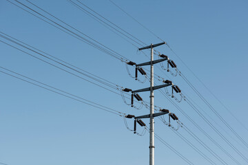 Wires and poles in the blue sky
