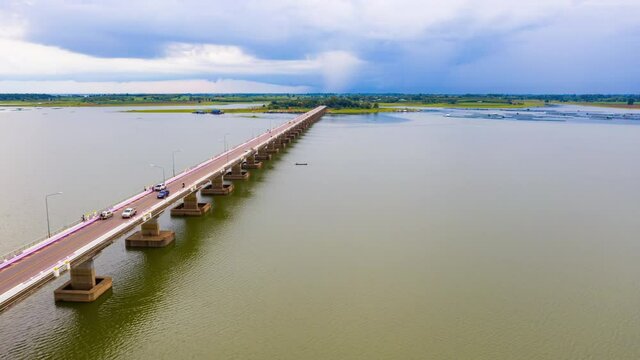 Hyper lapse 4k of aerial view across vehicles on Thep Sada Bridge  2-lane reinforced concrete bridge across Lam Pao Dam at Kalasin, Thailand