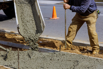 Truck mixer pouring concrete cement for construction sidewalk