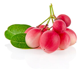 Fresh organic Carunda or Karonda fruits with green leaves isolated on white background