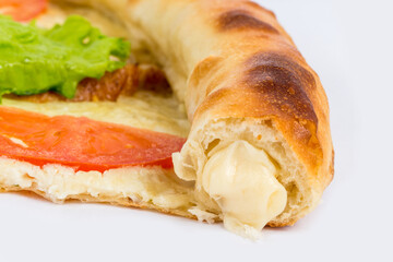 Slice of pizza with cheese rim on white background