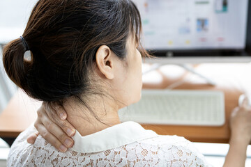 Tired asian woman with back neck and shoulders pain on muscle,stiff neck,symptom sore,painful while...