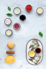 Assorted plate different oyster sauces in round gravy boats