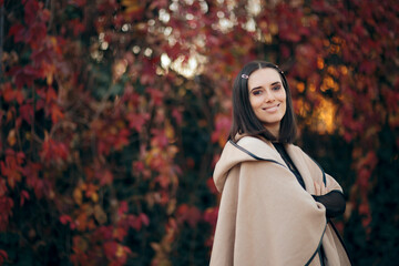 Autumn Fashion Woman Wearing a Poncho Outdoors