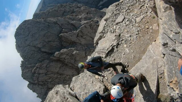 Olymp, Greece - 22 Jul, 2018: Mountaineer pov to expedition climbing to Mytikas rocky summit on Olympos mountain in Greece, vertical orientation