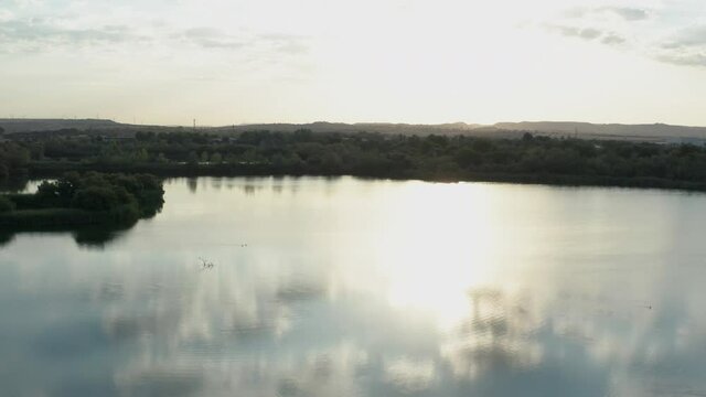 Laguna El Picon De Los Conejos near Madrid in Spain. Sun reflection on water. Aerial drone shot.