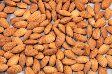 Almonds seed on dark background. Healthy food for peple who want to lose weight.