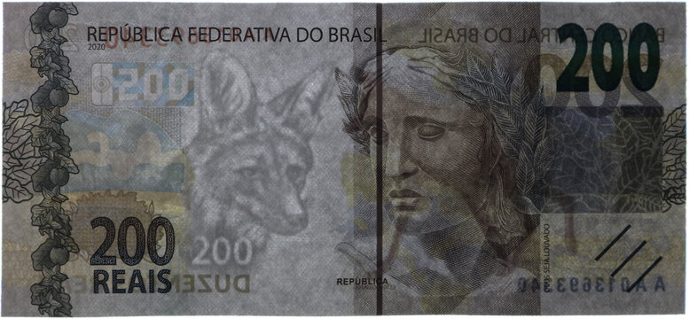 200 reais bill exposed over white light, revealing watermark and security thread.