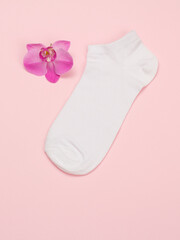 One woman sock on a pink background.