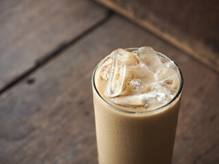 glass of iced coffee with wooden background