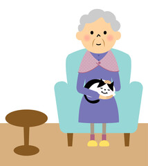 猫を抱いてソファーに座るおばあちゃん