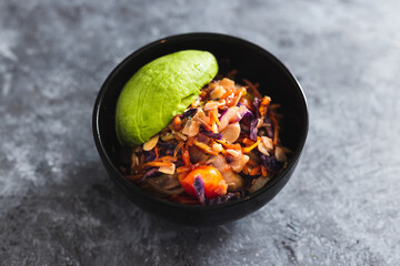 plant-based food, vegan salad bowl with teriyaki sauce salad mix almonds and avocado