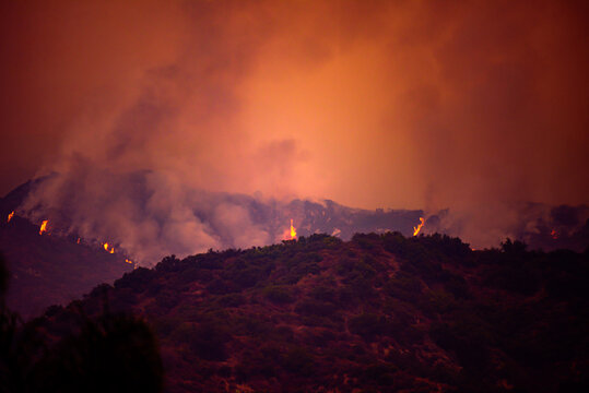 Smoke and fire in the woods near Los Angeles. The problem of California. Large fires started burning, prompting fresh waves of evacuations and sending plumes of smoke into the air.