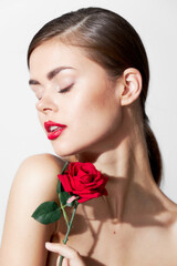 Woman with flower Eyes closed rose in the hands of luxury 