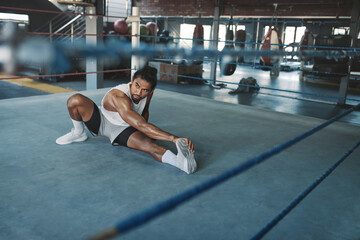 Fototapeta premium Man Stretching On Boxing Ring. Asian Male Sportsman Warming Up Before Workout. Training At Fitness Center For Strong, Healthy Muscular Body. Sexy Guy Doing Flexibility Exercise.