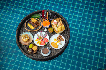 Floating breakfast, a large sturdy tray in the pool, complete morning meal, with hot beverages, warm bread and condiments