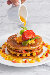 delicious pancakes on marble table with fruits