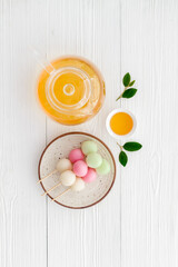 Japanese tea and sweet dumplings Dango on plate, top view
