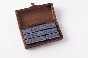 Letters stamping in a wooden camera on a white background.