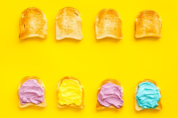 Layout of sandwiches with colored butter and cheese spread, top view