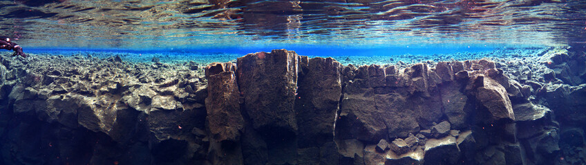 wide panorama of underwater rock wall in silfra, iceland