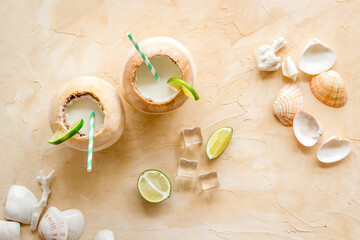 Raw coconut water or milk with straw, above view