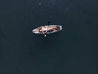 Attractive Woman on Stand Up Paddle Board, Woman paddling on sup board and enjoying turquoise...