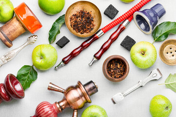 Smoking shisha on green apple