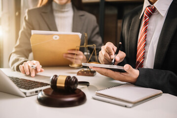 Teamwork of business lawyer meeting working hard about legal legislation in courtroom to help their...