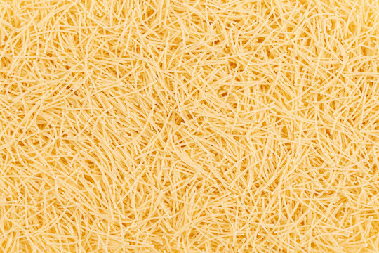 Uncooked vermicelli pasta background. Close up of raw vermicelli pasta