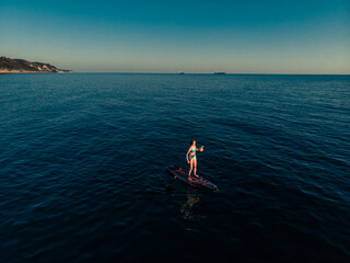 Attractive Woman on Stand Up Paddle Board, Woman paddling on sup board and enjoying turquoise...