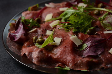 Beef Carpaccio  with parmesan, capers and arugula. With olive oil and soy sauce