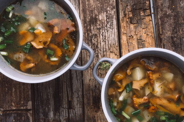 soup with chanterelles and herbs in two bowls