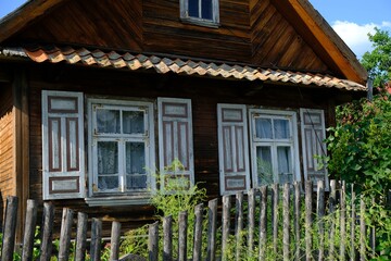 Beautiful wooden house with 
decorative shutters in the village, Podlasie, Poland. This area is called the Land of Open Shutters
