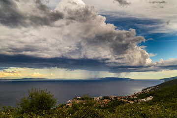 Dramatic storm scenery over the Adriatic Sea, with dark cumulus rain clouds