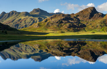 Naklejka na ściany i meble Reflections of the Langdales in Blea Tarn in the English Lake District, UK