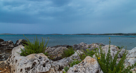 Fototapeta na wymiar Rock formations on the Adriatic Sea in summer, under warm evening light