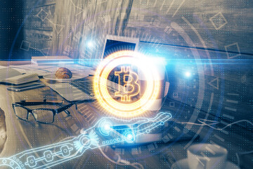 Double exposure of blockchain theme hologram and table with computer background. Concept of bitcoin crypto currency.
