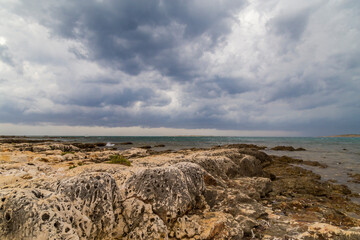 Fototapeta na wymiar Dramatic storm scenery over the Adriatic Sea, with dark cumulus rain clouds