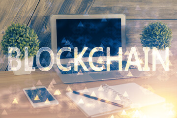 Double exposure of blockchain theme hologram and table with computer background. Concept of bitcoin...