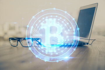 Multi exposure of blockchain theme hologram and table with computer background. Concept of bitcoin...